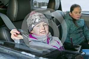 Caucasian girl in warm clothes traveling in a car