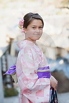 Caucasian girl wearing a traditional Japanese kimono