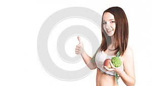 Caucasian girl.Weight loss, slim body, diet, sport, fitness and health concept. young beautiful woman holding broccoli and apple