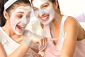 Caucasian girls wearing peeling mask having fun