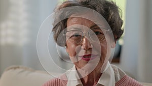 Caucasian grandmother senior woman looking away turn to camera smile toothy happy old mature female elderly granny in