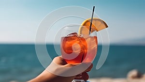 caucasian hand holding glass of red fruit cocktail on blurry sea horizon background at sunny day, neural network