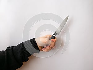 Caucasian hand holding a puntilla knife, over a white background photo