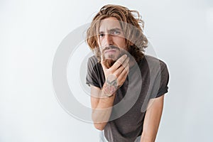 Caucasian handsome young bearded man standing isolated