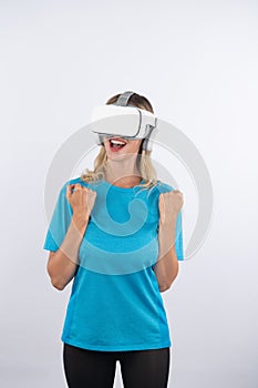 Caucasian happy girl making winner gesture while using VR glasses. Contraption.