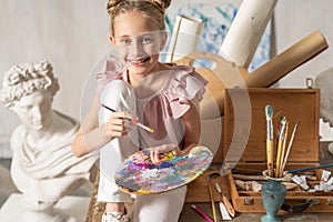 Caucasian happy little girl posing for camera indoors