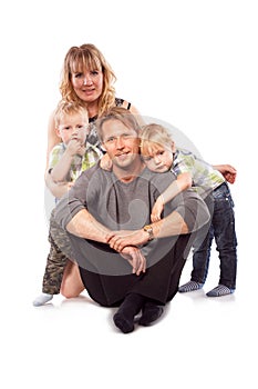 Caucasian happy smiling young family with two children sitting o