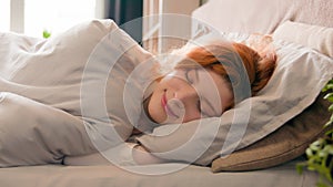 Caucasian happy woman sleeping in comfortable cozy bed at home girl lady asleep lying on soft pillow white linen