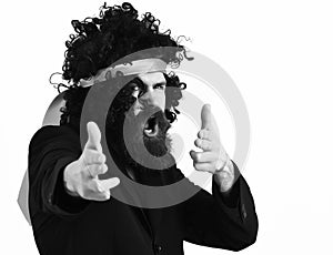 Caucasian hipster in suit and black curly tie-tied afro wig