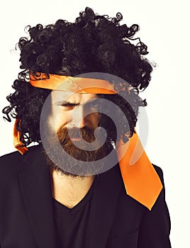 Caucasian hipster in suit and black curly tie-tied afro wig