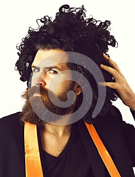 Caucasian hipster in suit and black curly wig