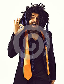 Caucasian hipster in suit and black curly wig