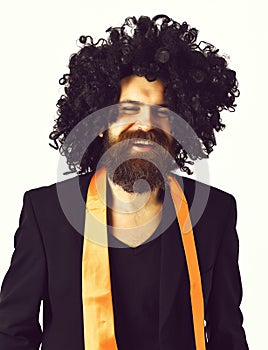 Caucasian hipster in suit and black curly wig