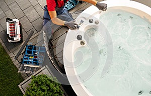 Caucasian Hot Tub Technician Servicing Circular Garden SPA