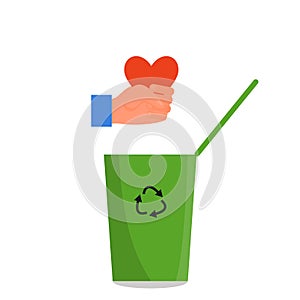 Caucasian human hand holding red heart in fist over the green trash can. Concept of divorce, tough business, cruelty, callousness