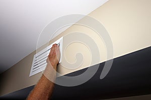 Caucasian Human Hand Placed on a Right Side of Wall Air Vent