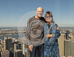 Caucasian husband and Korean wife posing in the immersive art experience of SUMMIT One Vanderbilt in New York City.
