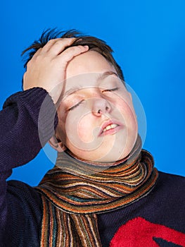 Caucasian ill boy dressed with neckscarf