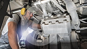 Industry Mechanic Performing Diesel Pusher Maintenance photo