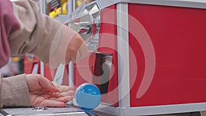 Caucasian Kid Buying Random Toy from Capsule Toy Vending Machine at Amusment Park or Festival Top View