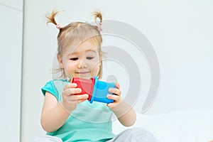 Caucasian kid playing with colorful toys at home