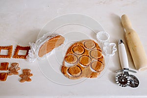 Caucasian kids cuts flattened dough into shapes. Process of making forms biscuits or gingerbread. Family activity at home.