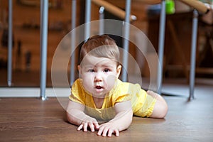 Caucasian little baby boy crawling on floor at home