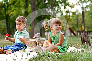 Caucasian little boy and girl eating sweets