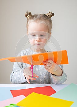 Caucasian Little Girl Cutting with Scissor Colorful Paper