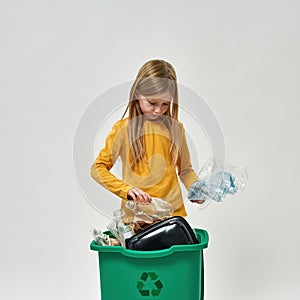 Caucasian little girl hold bottles from dustbin