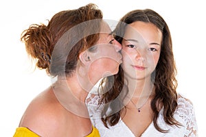 Caucasian lovely women adult mother kiss cheek her teenage daughter girl standing isolated over white background