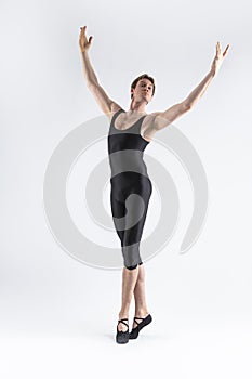 Caucasian Male Ballet Dancer Flexible Athletic Man Posing in Black Tights in Ballanced Dance Pose