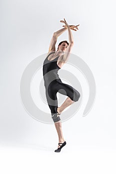 Caucasian Male Ballet Dancer Flexible Athletic Man Posing in Black Tights in Ballanced Dance Pose With Hands and Leg