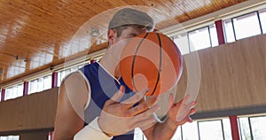 Caucasian male basketball player practicing dribbling and shooting with ball