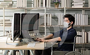 Caucasian male broker trader freelancer businessman sitting in wheelchair wearing face mask with looking computer about stock