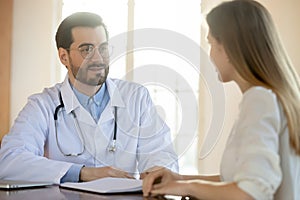 Caucasian male doctor consult female patient in clinic