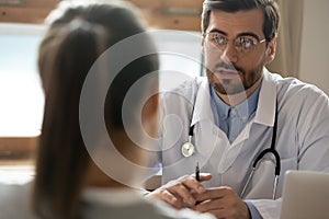 Caucasian male doctor talk consult female patient