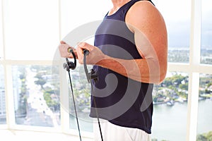 Caucasian male doing resistance training indoors