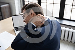 Caucasian male employee struggle with neck pain