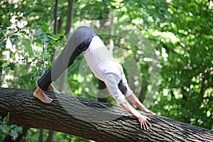 Caucasian male in formal clothes doing downward facing dog