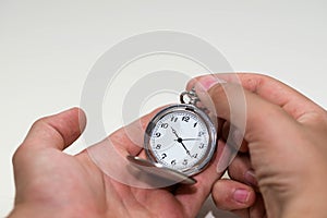 Caucasian male hand adjusting the pocket watch