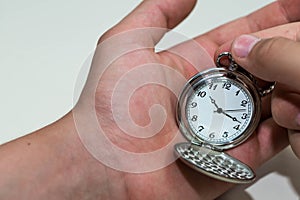 Caucasian male hand adjusting the pocket watch