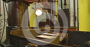 Caucasian male hands factory worker at a factory standing at a workbench and operating a machinery