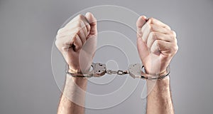 Caucasian male hands in handcuffs. Arrest
