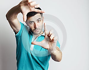 Caucasian male making photo frame with his hands