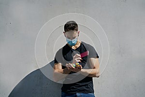 Caucasian male in medical masks with virus mock-ups and passport. Concept of not being able to travel and move around the