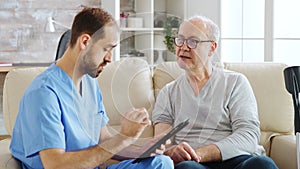 Caucasian male nurse talking with a nursing home patient about his health
