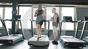 Caucasian Male Personal Trainer Guiding a Group of Energetic People through a Workout