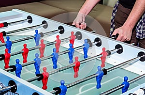 Caucasian male playing table soccer game