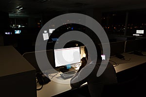 Caucasian male programmer sitting at desk, using computer with copy space on screen